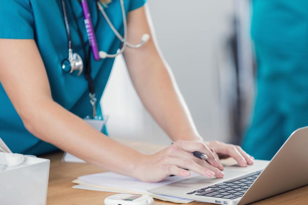 Health care worker using a laptop