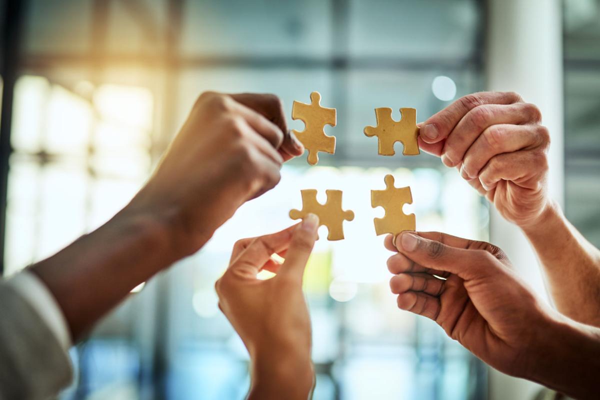 Hands holding puzzle pieces