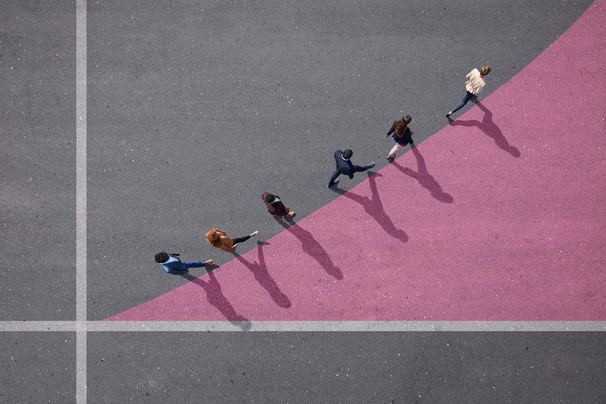 Group of people walking on painted tarmac surface