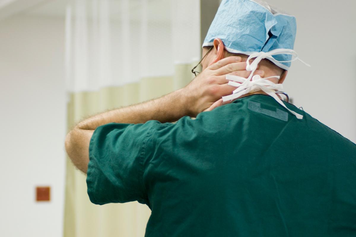 Physician with neck pain, facing forward
