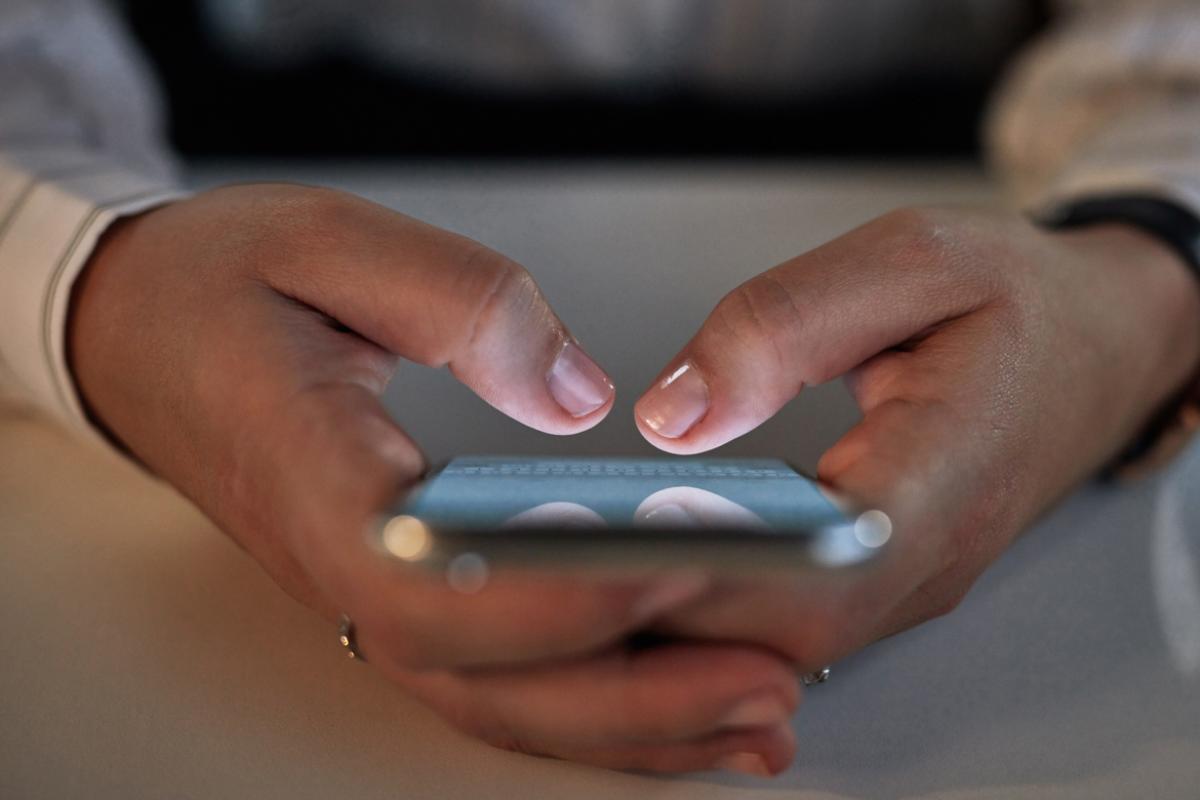 Hands using a smartphone