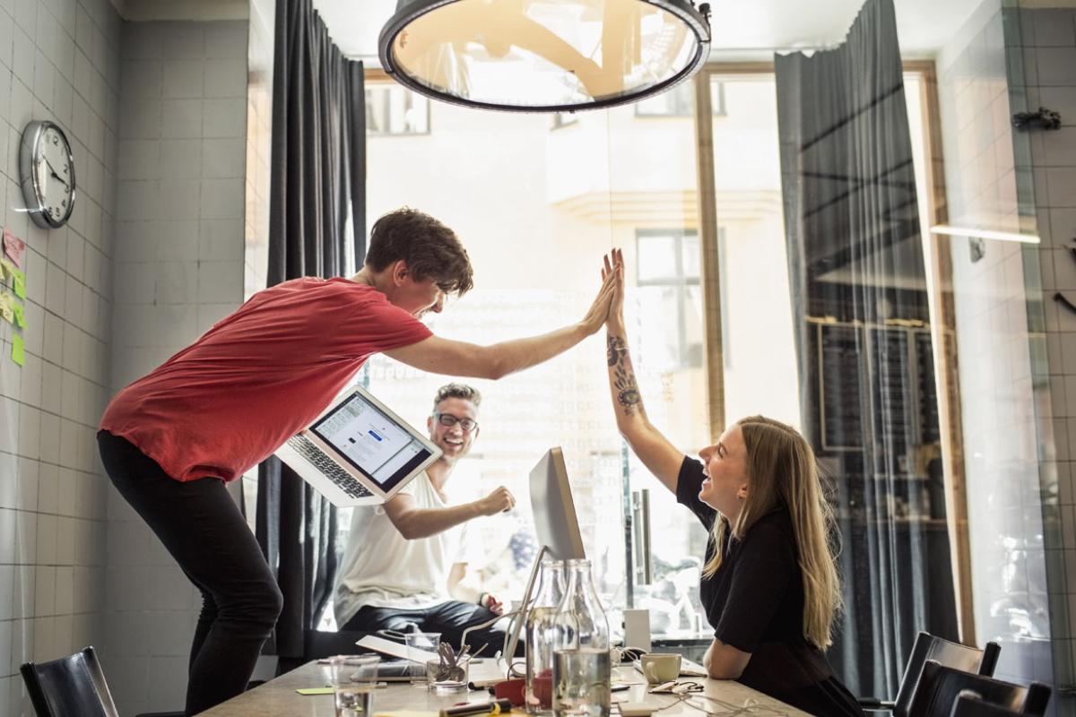 Two people giving one another a high five