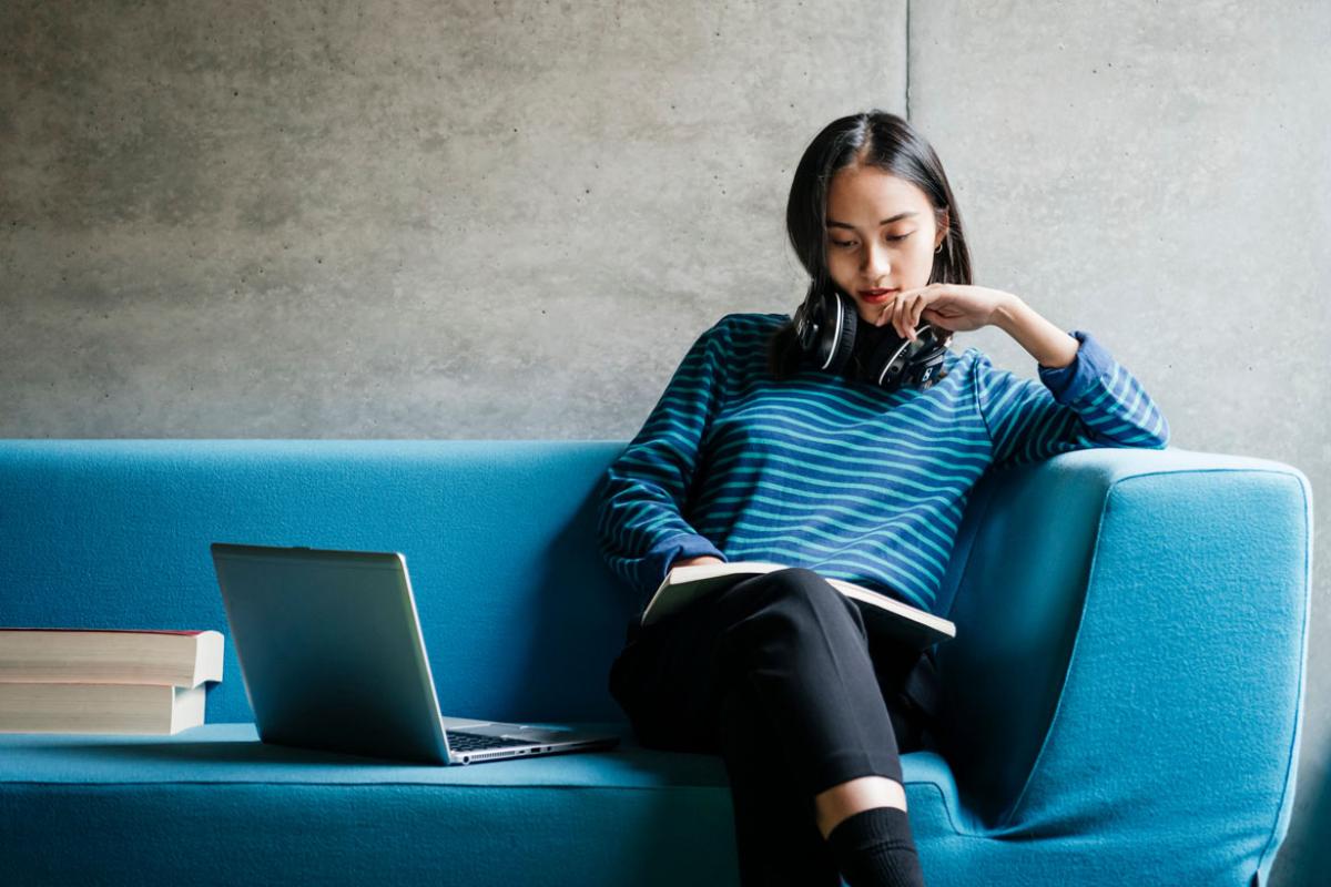 Person sitting on a couch and reading