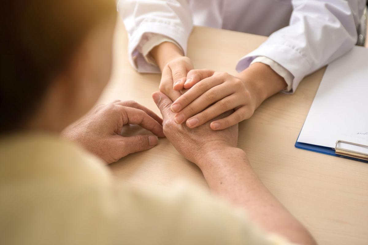 Physician holding a patient's hands