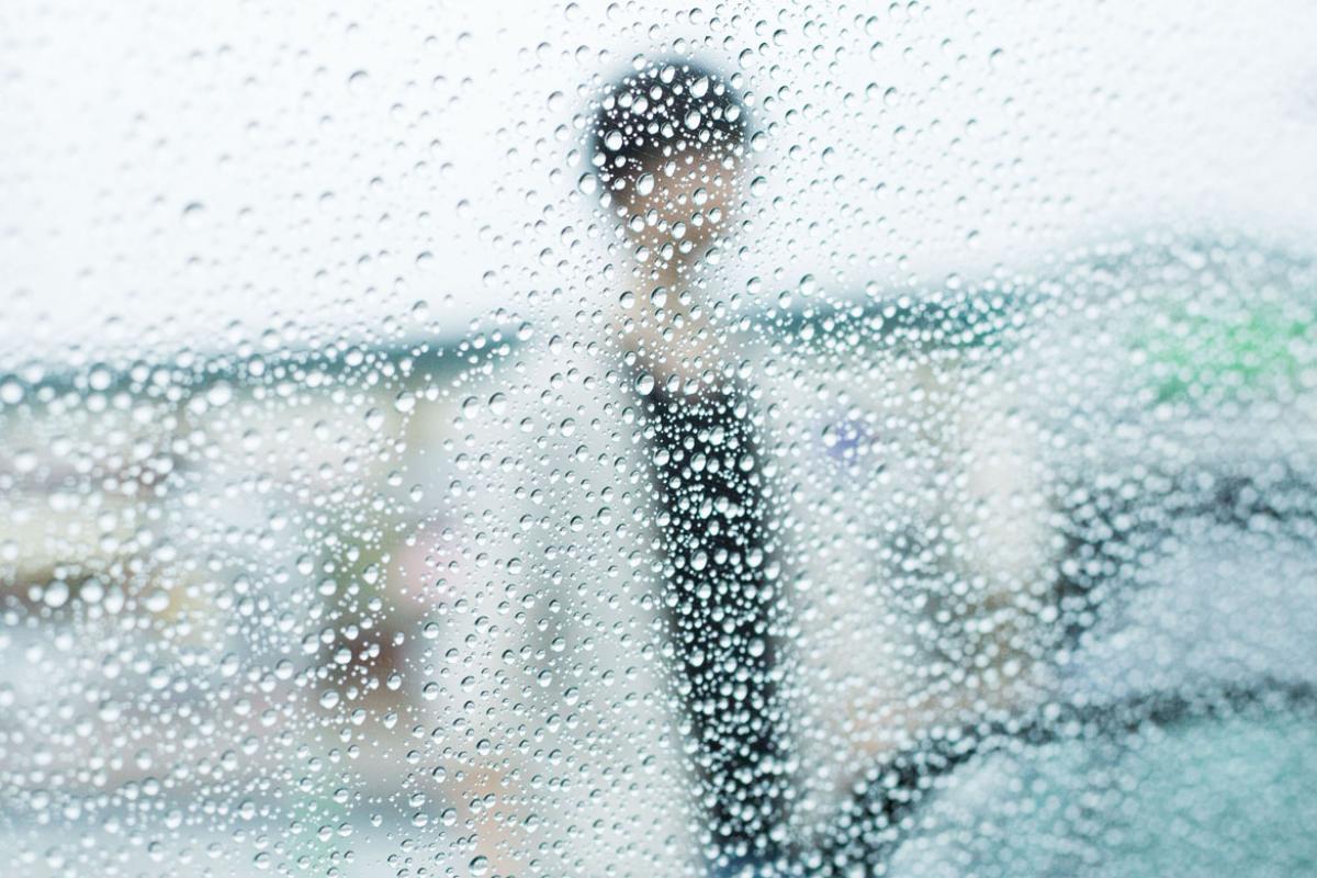 Person behind a wall of drops of water