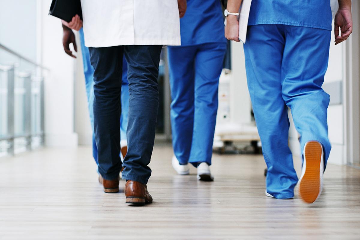 Health care workers walking down a hallway