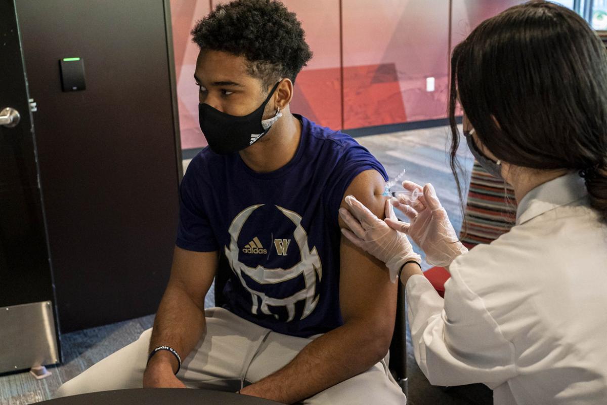 Teenager receiving vaccine