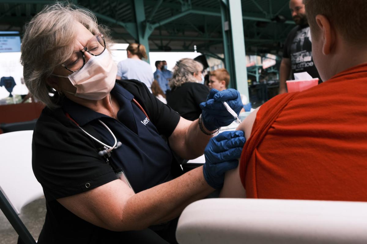 Health care worker administering vaccine