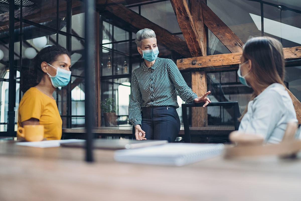 Three women having a meeting at an open office space