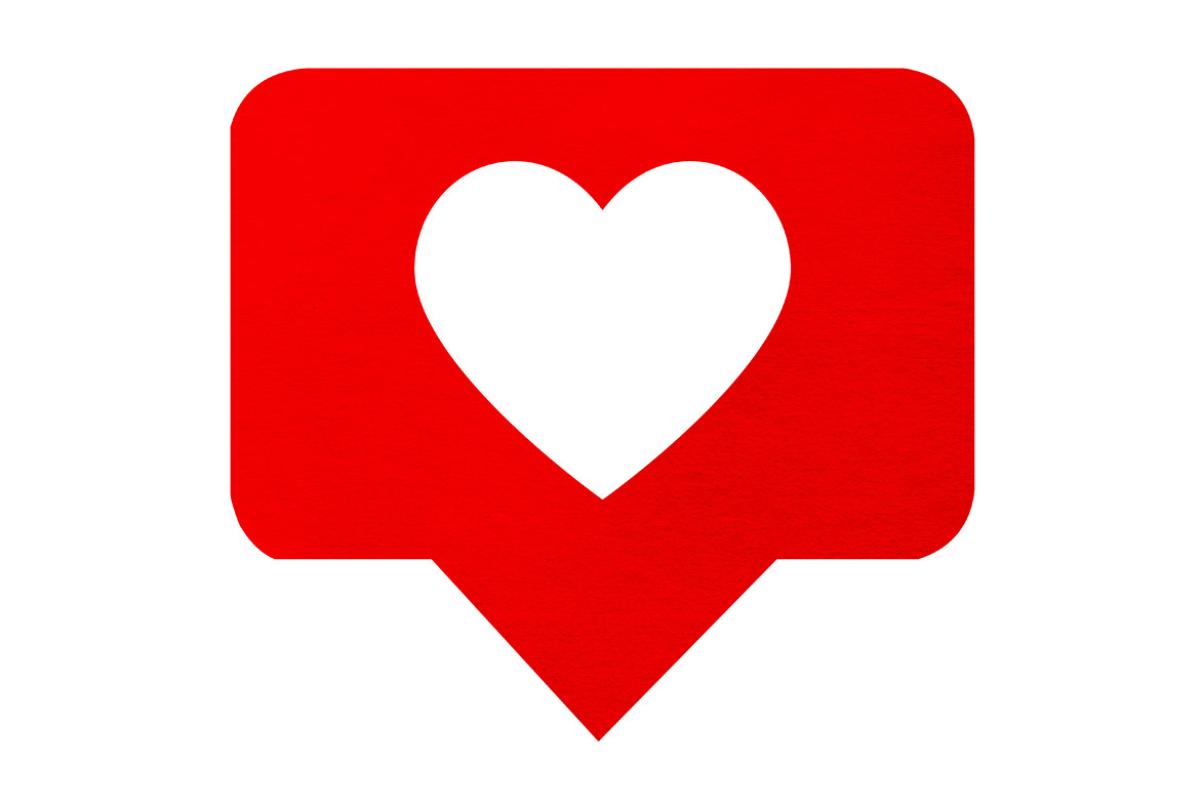 Red speech or conversation bubble with a white heart in the middle