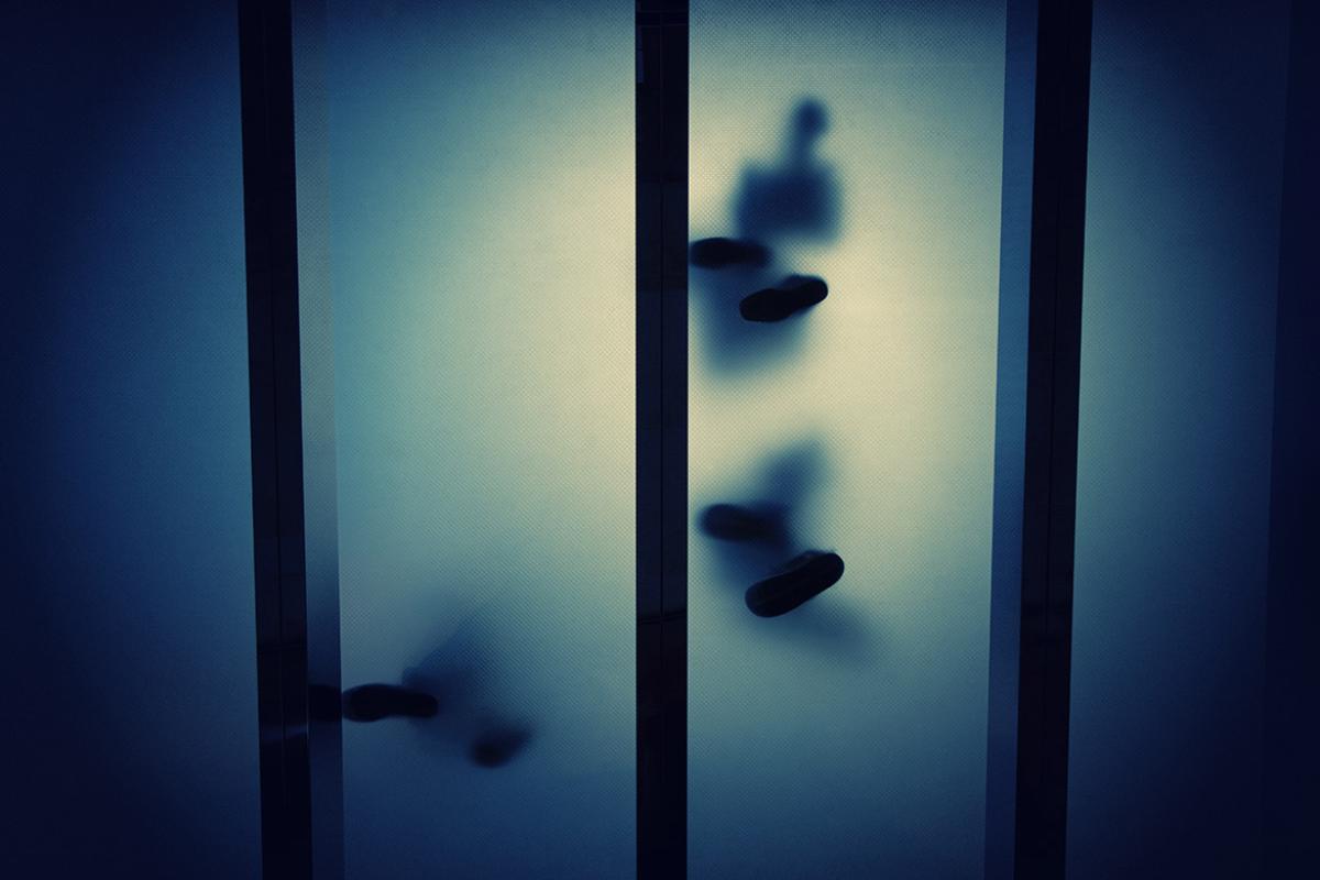 Feet seen through transparent glass panels