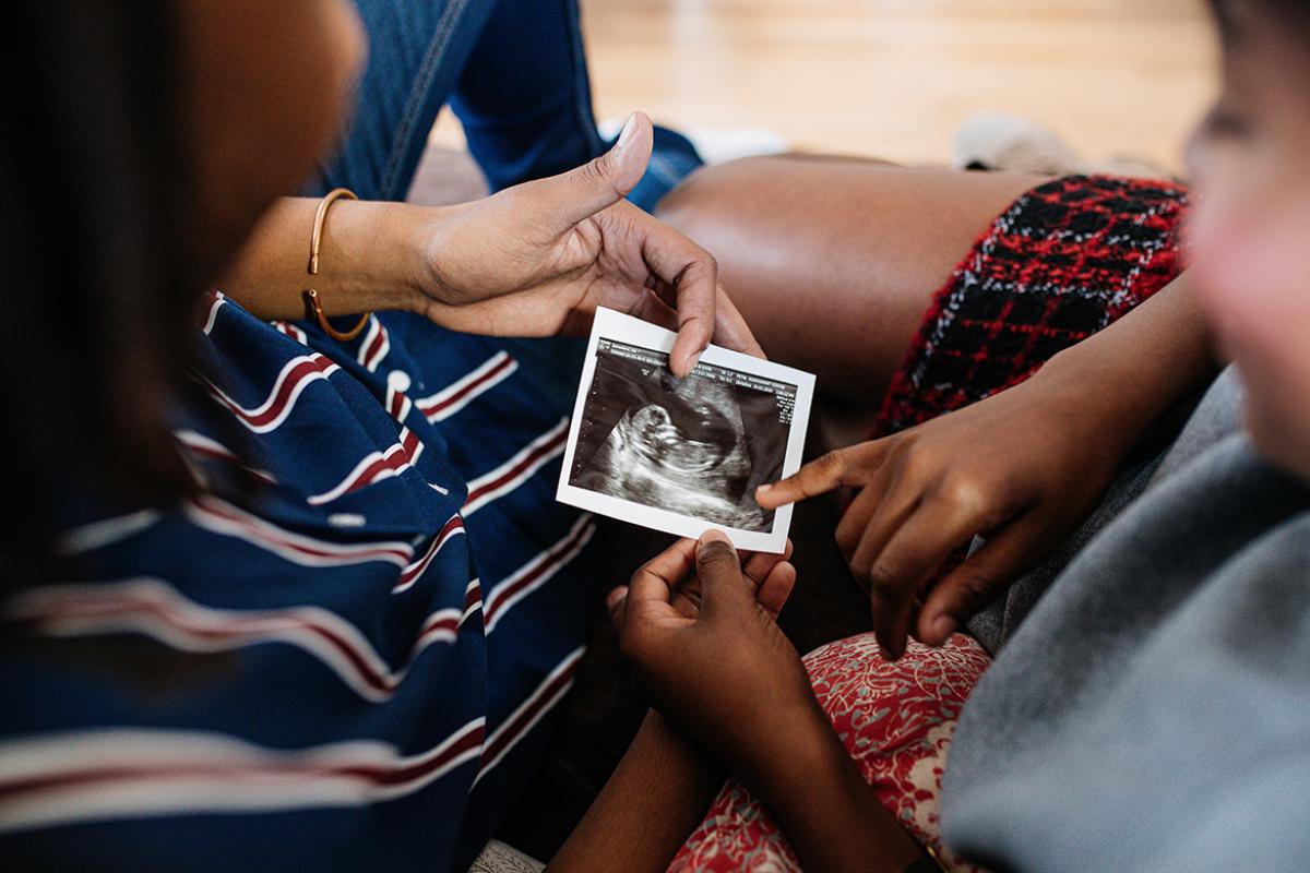 A couple looking at a pregnancy trimester ultrasound image