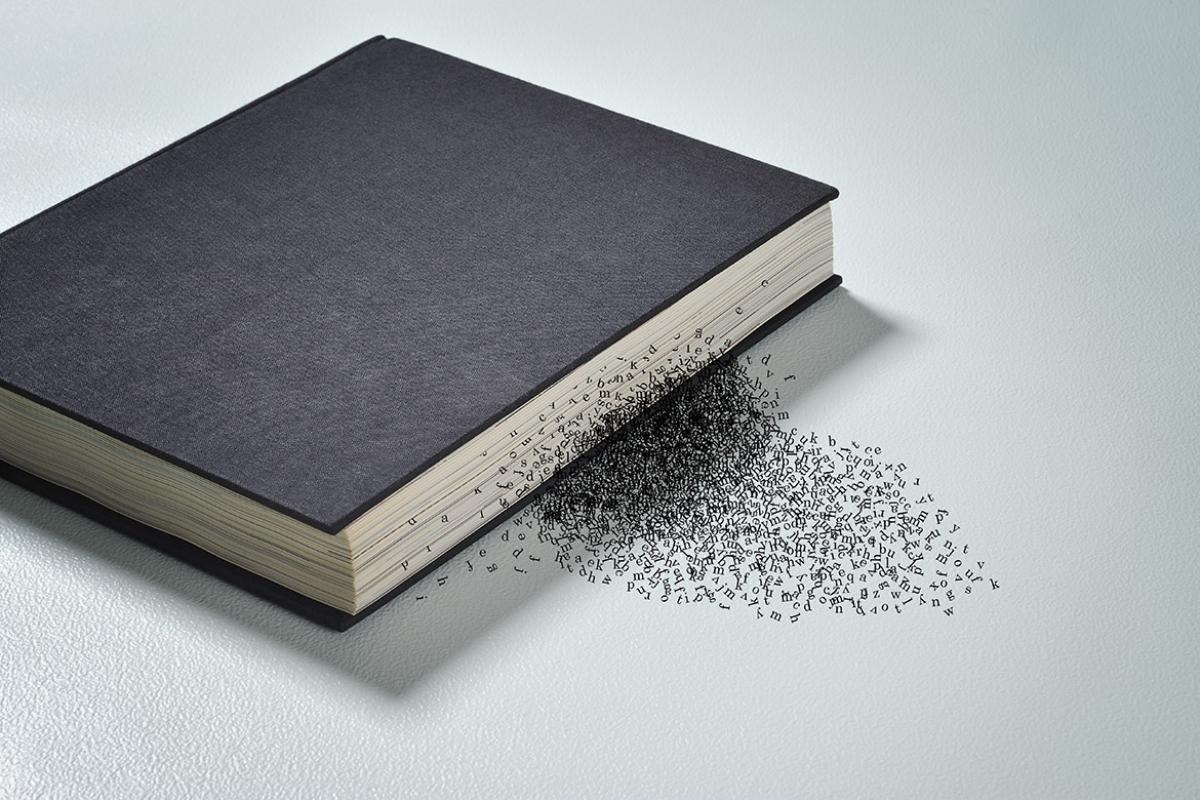 Book with letters spilling out from the pages
