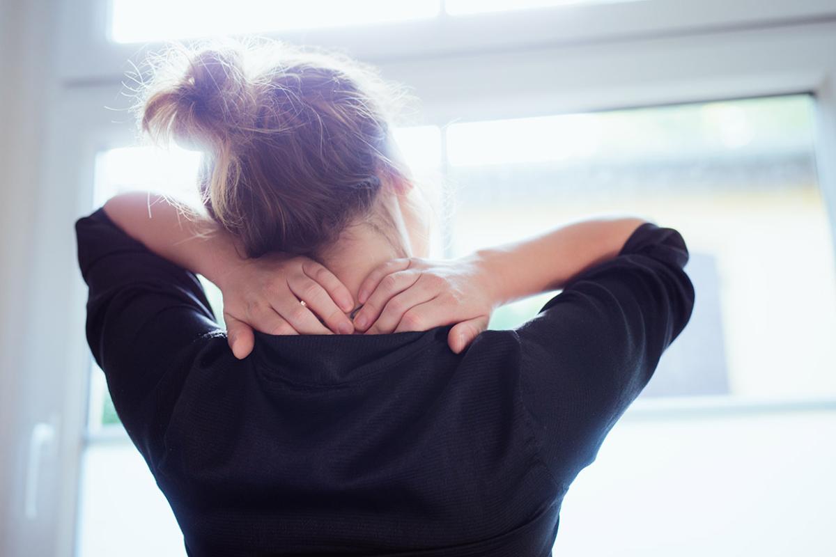 Person rubbing neck