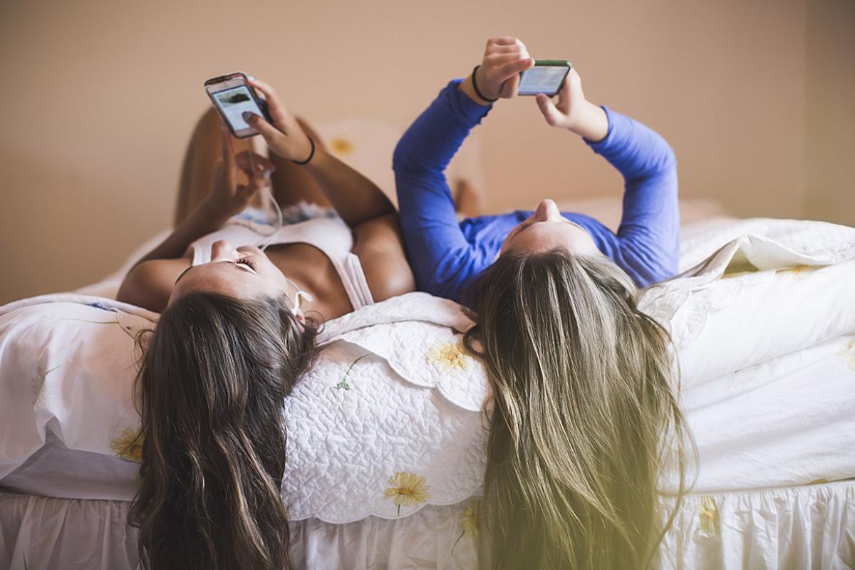 Two people looking at smartphones