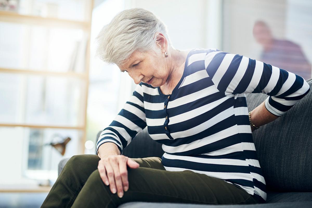 Woman with her arm on her mid-back