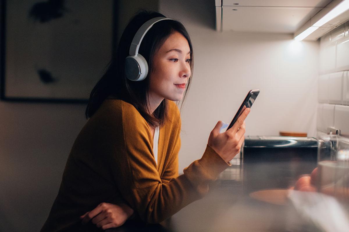 Smiling person looking at smartphone