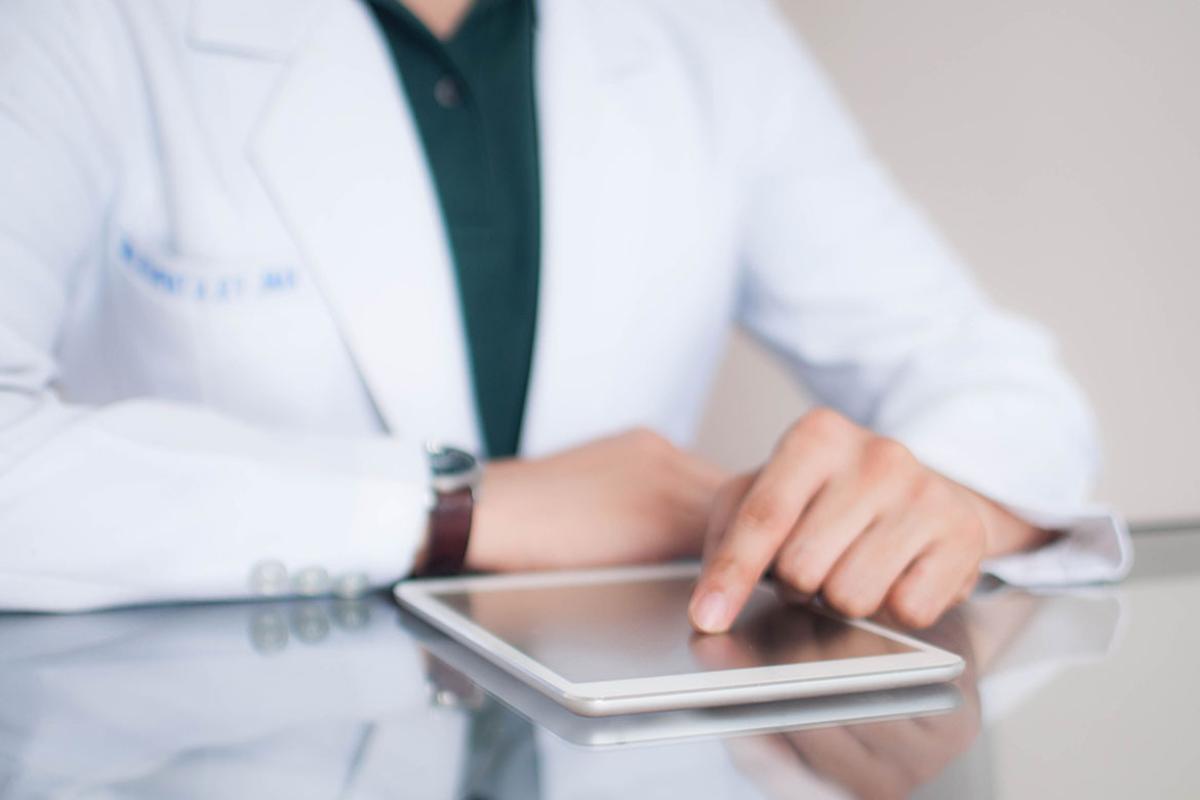 Person with a finger on a tablet