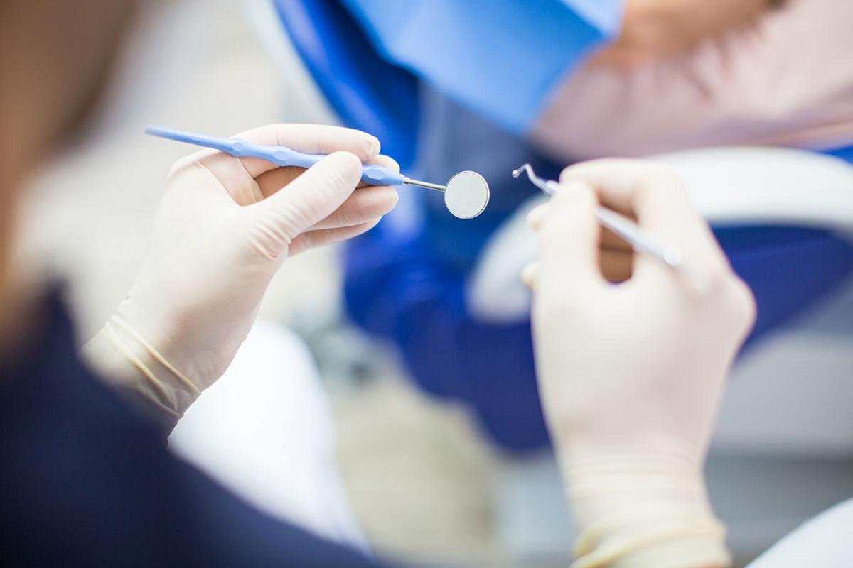 Hands holding dental tools