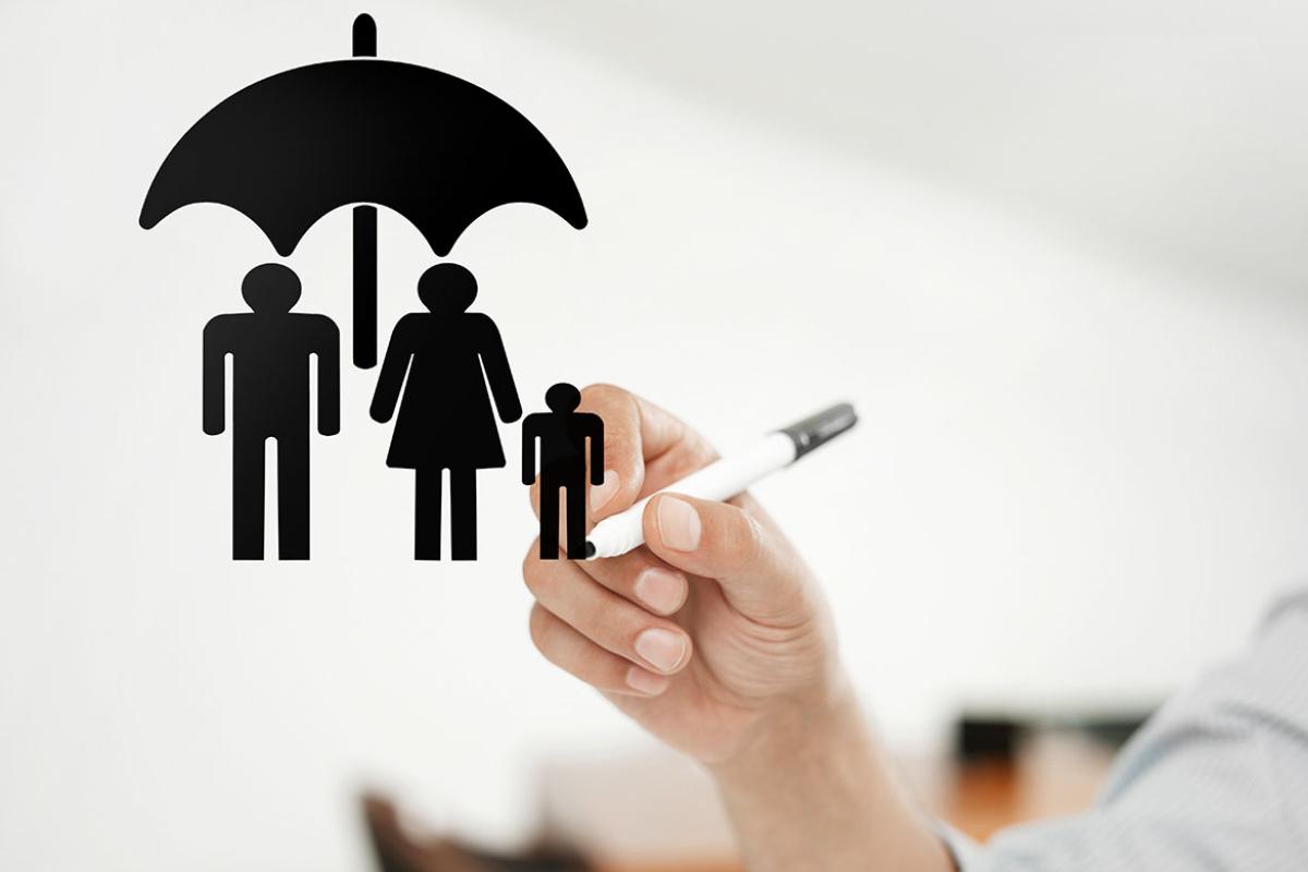 Three figures under an umbrella