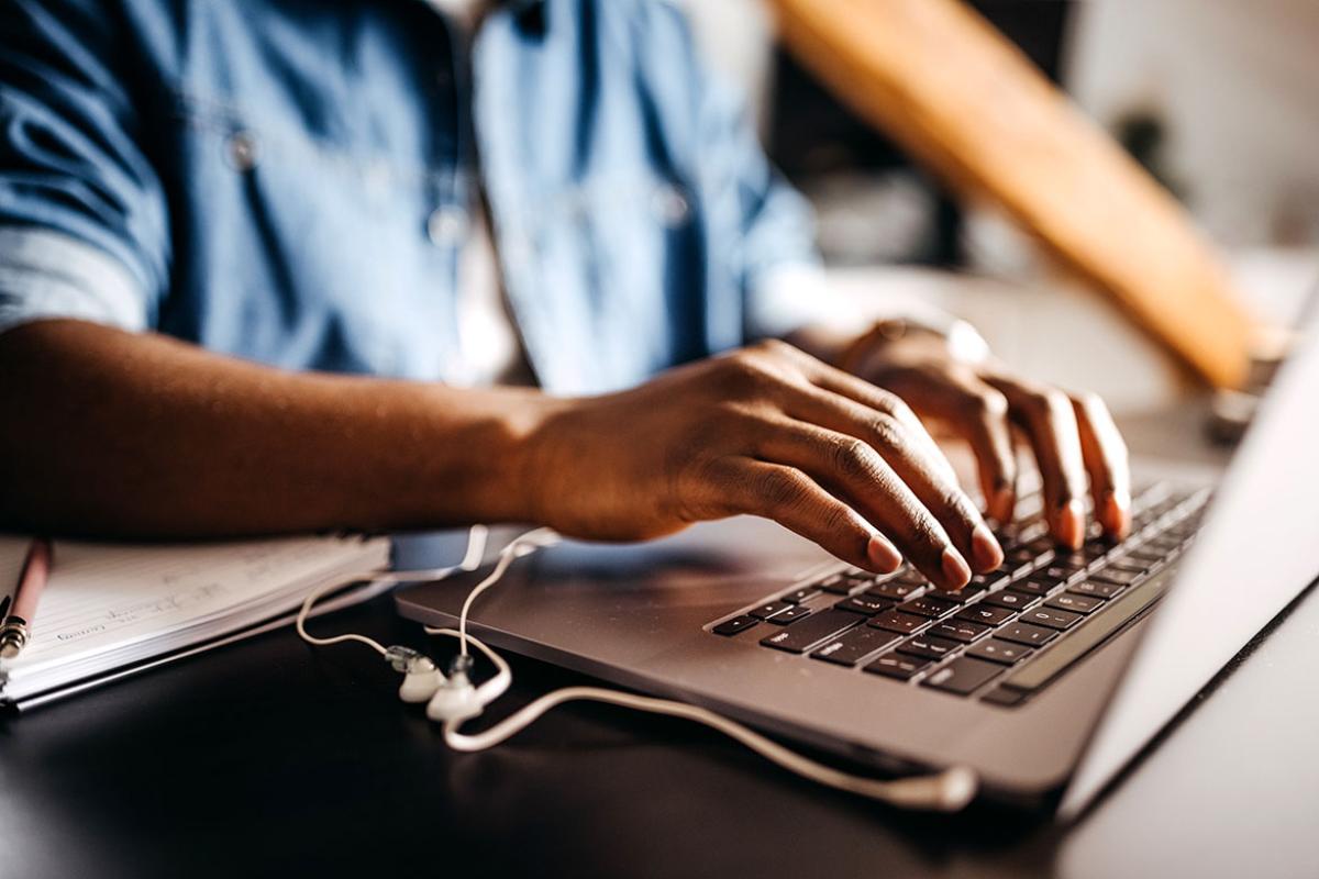 Hands on a laptop