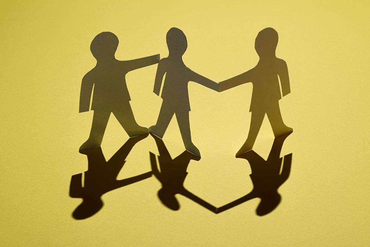 Three paper cut out figures