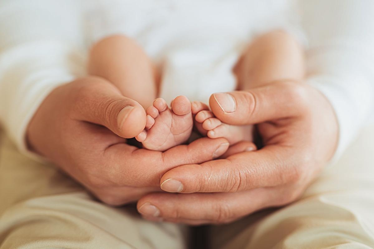 Person cradling an infant