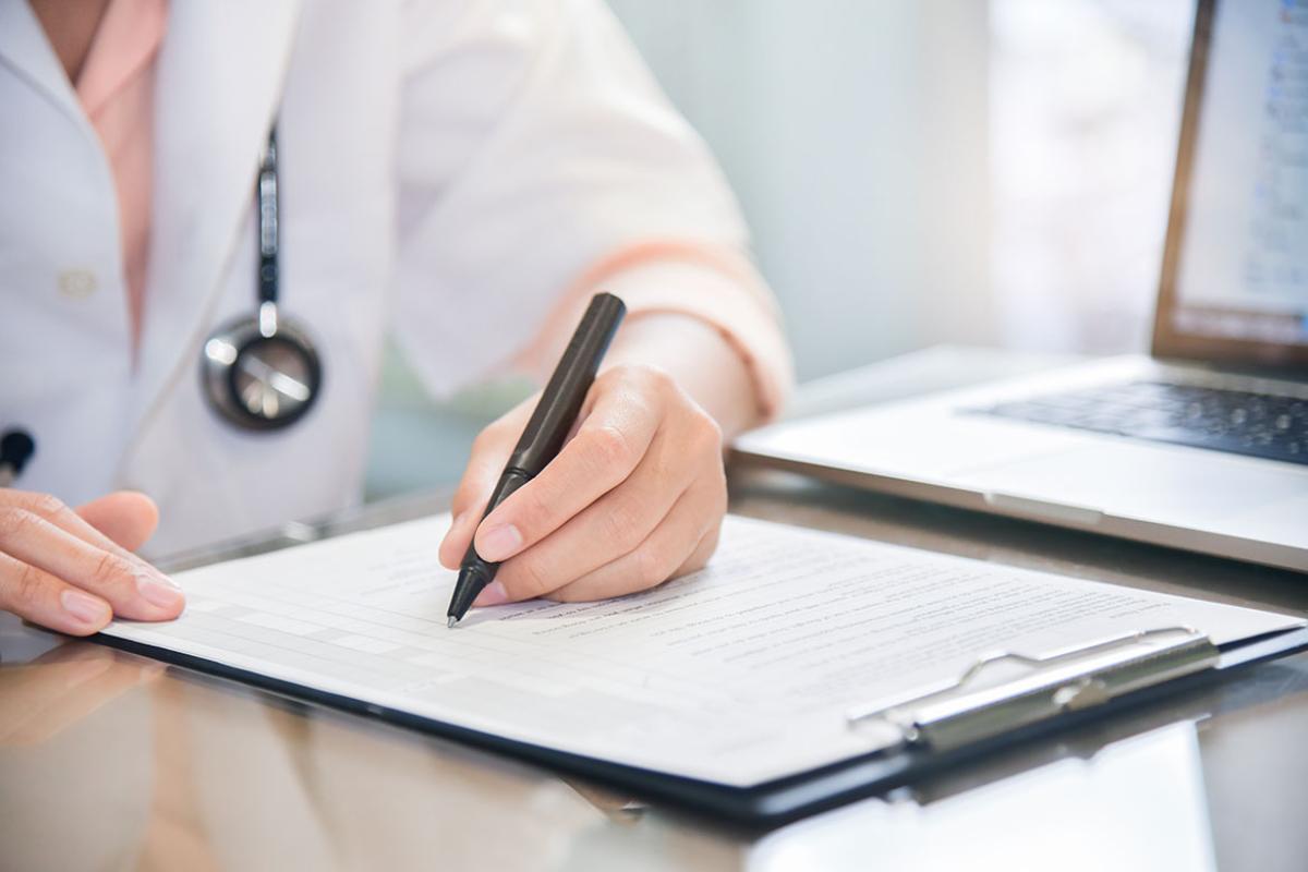 Physician filling out a form