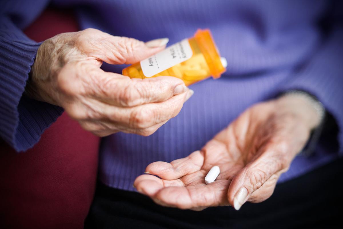 Hand holding prescription medication