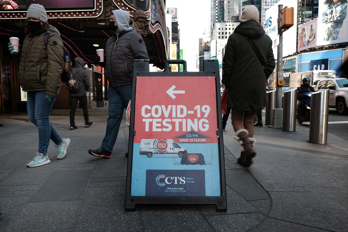 People pass Covid-19 testing site along a Manhattan street