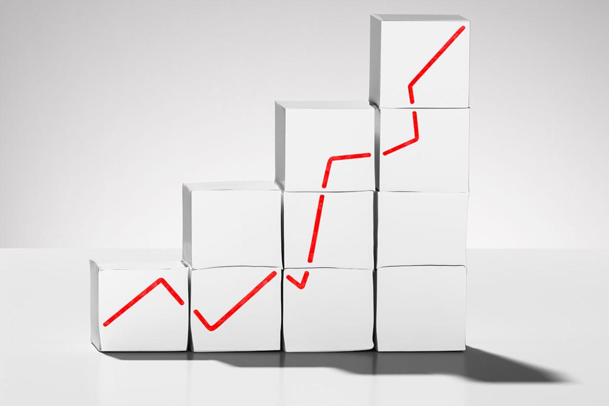 A set of white boxes with a red line graph growing upwards 