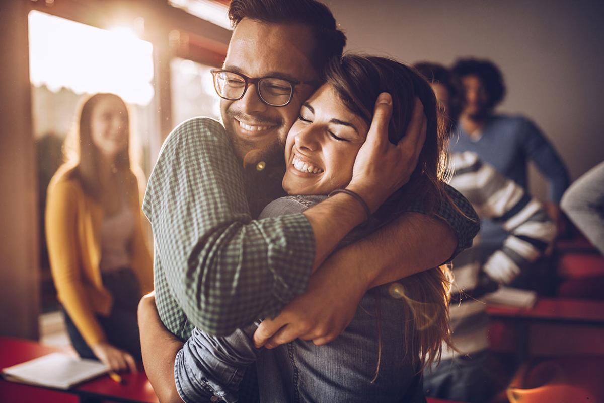 Smiling people in an embrace