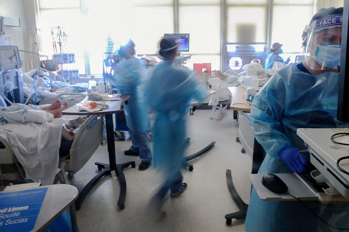 Intensve Care Unit (ICU) with health care professionals treating COVID-19 patients