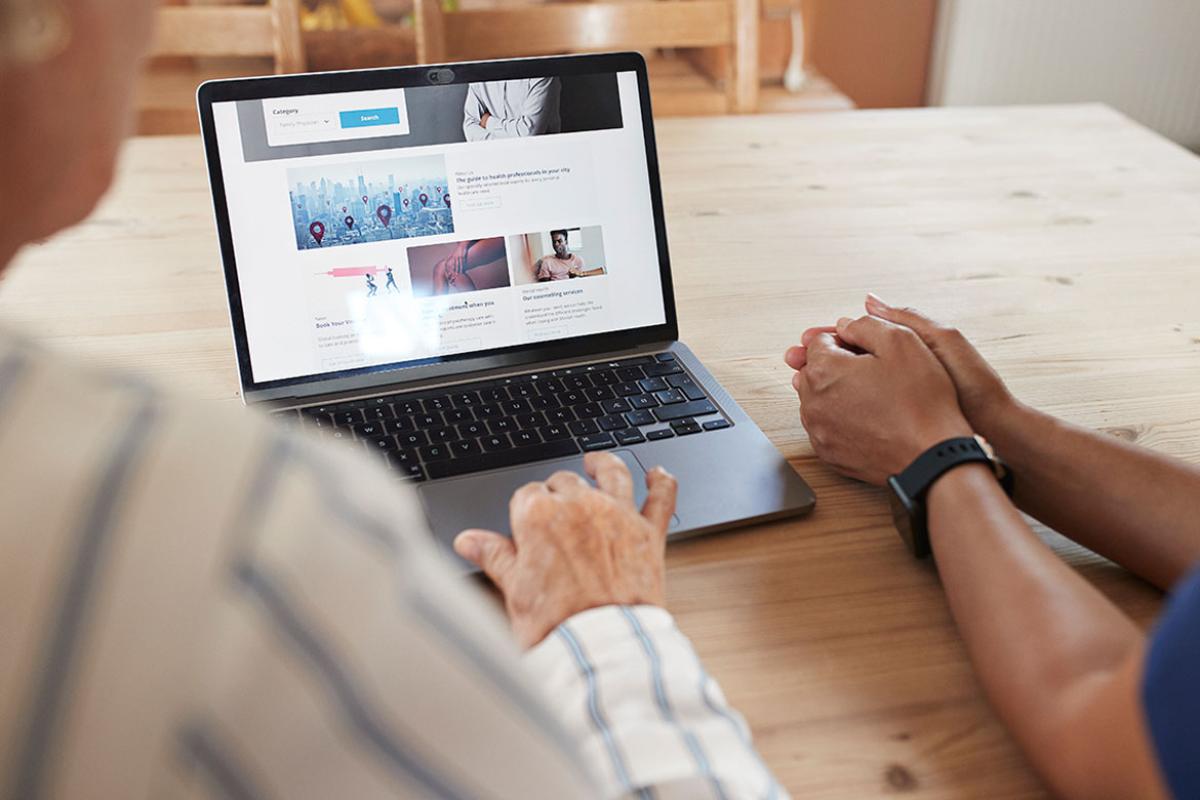 Two people using a laptop
