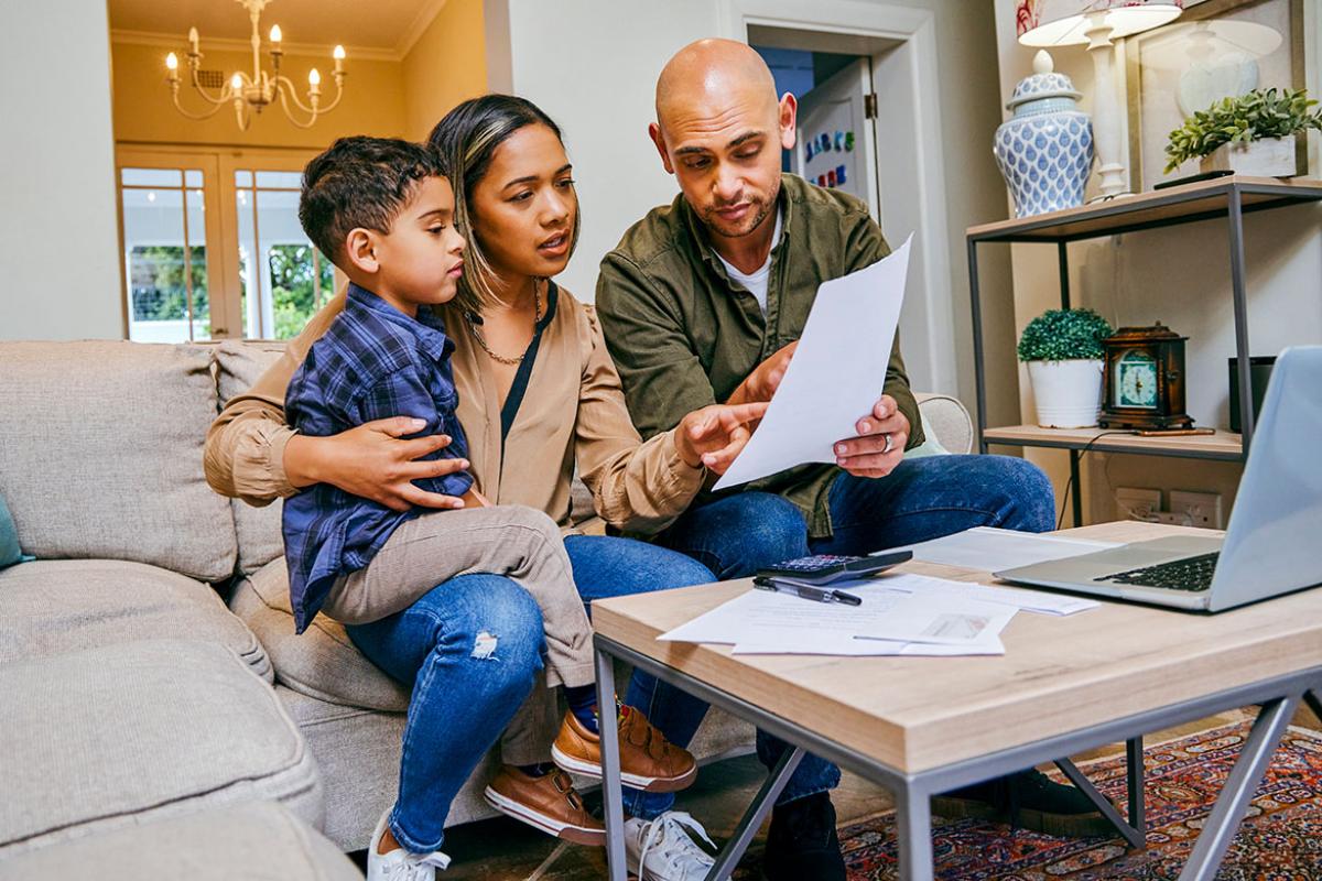 Family of three looking at a document