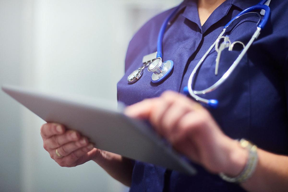 Health care professional using a tablet