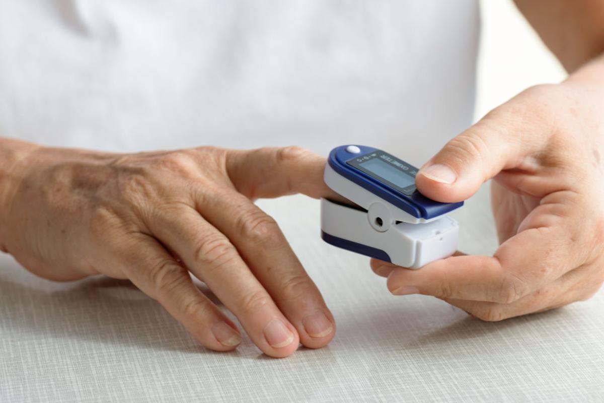 Hands using pulse oximeter