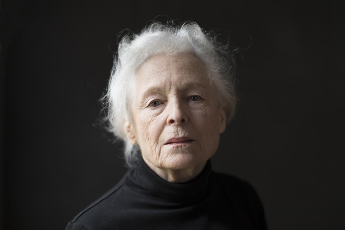 Image of woman dressed in black on black background