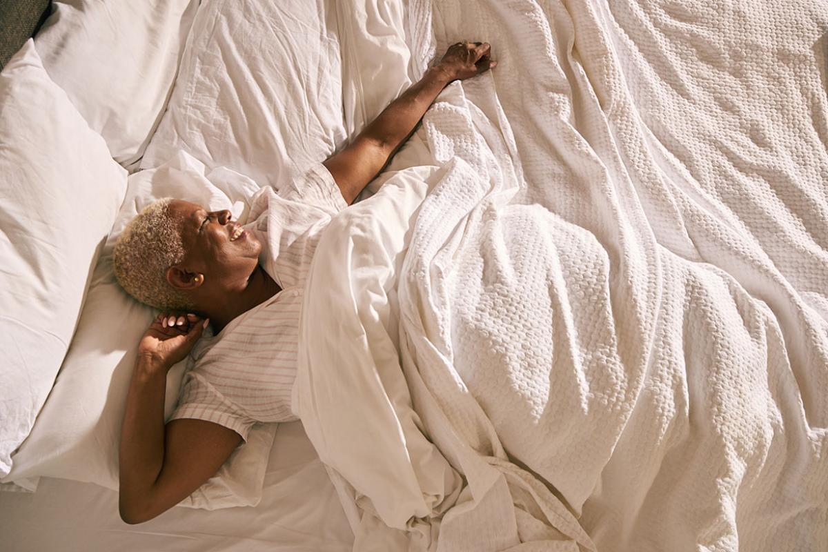 Smiling person in bed