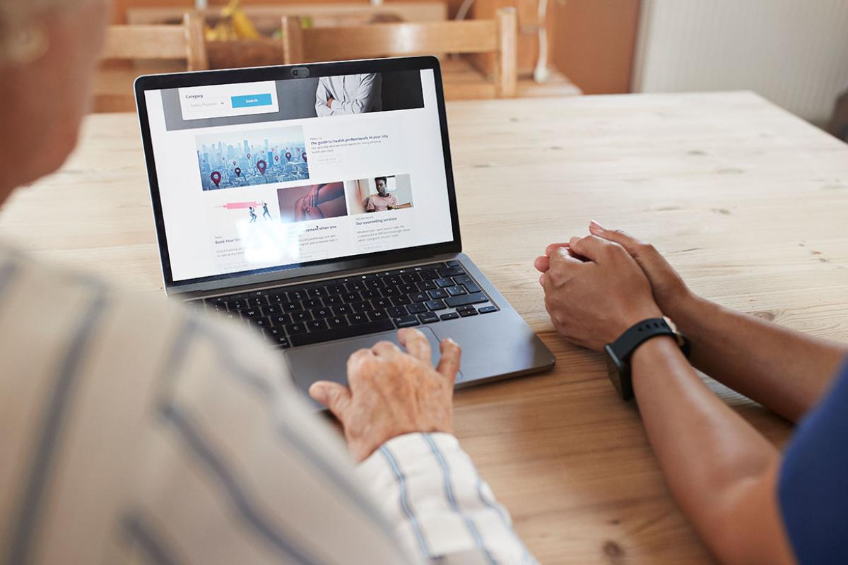 Two people looking at an online patient portal