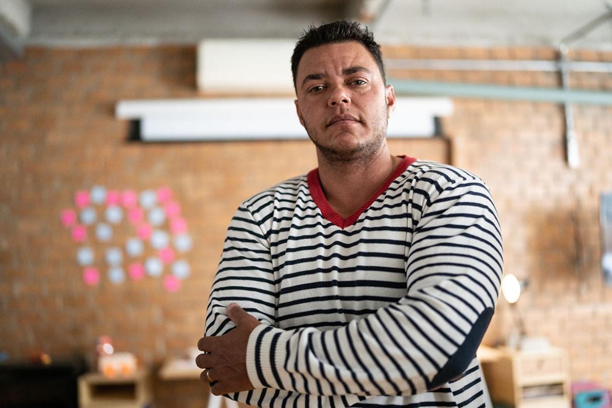 Transgender person standing in a room