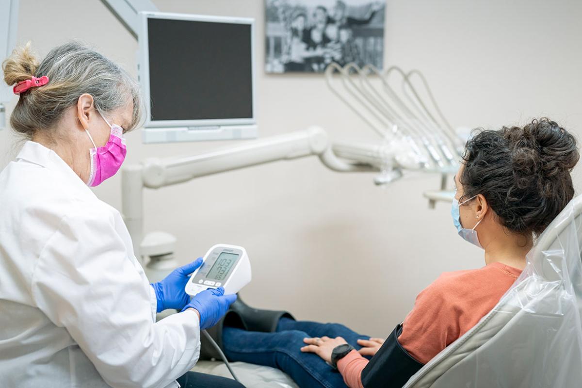 Health care professional measuring a patient's blood pressure