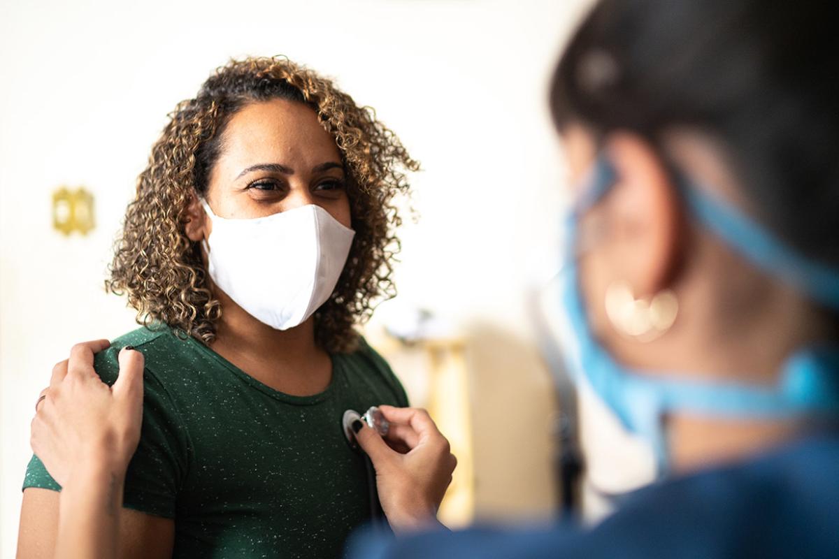 Smiling masked patient at a physician appointment