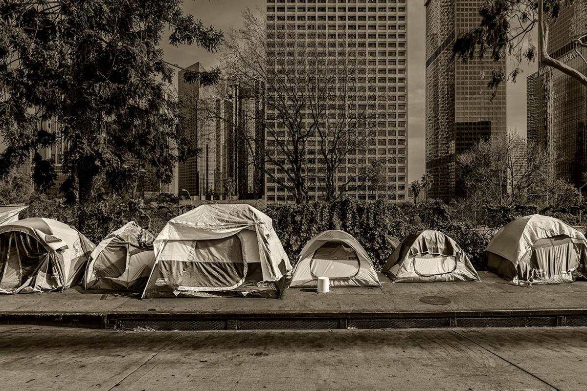 Homeless tents, skyscrapers in background 