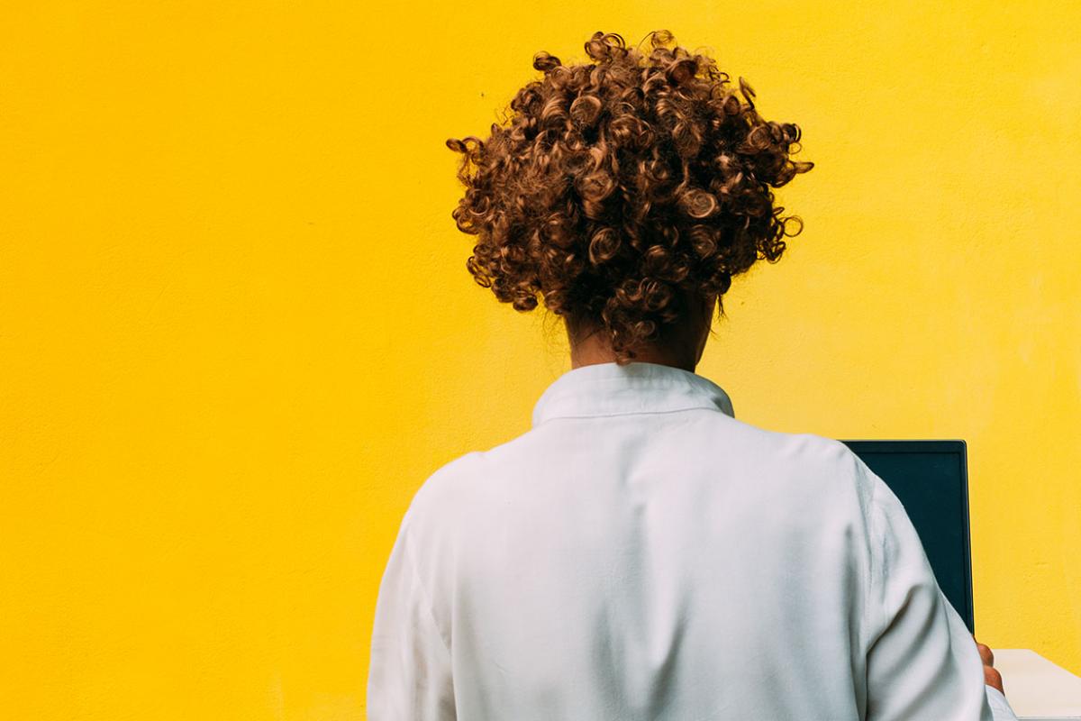 Back view of a person working at a computer