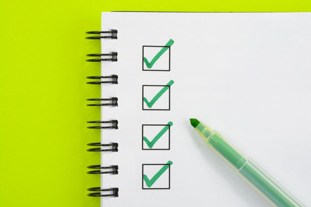 Four check boxes on a spiral-bound page