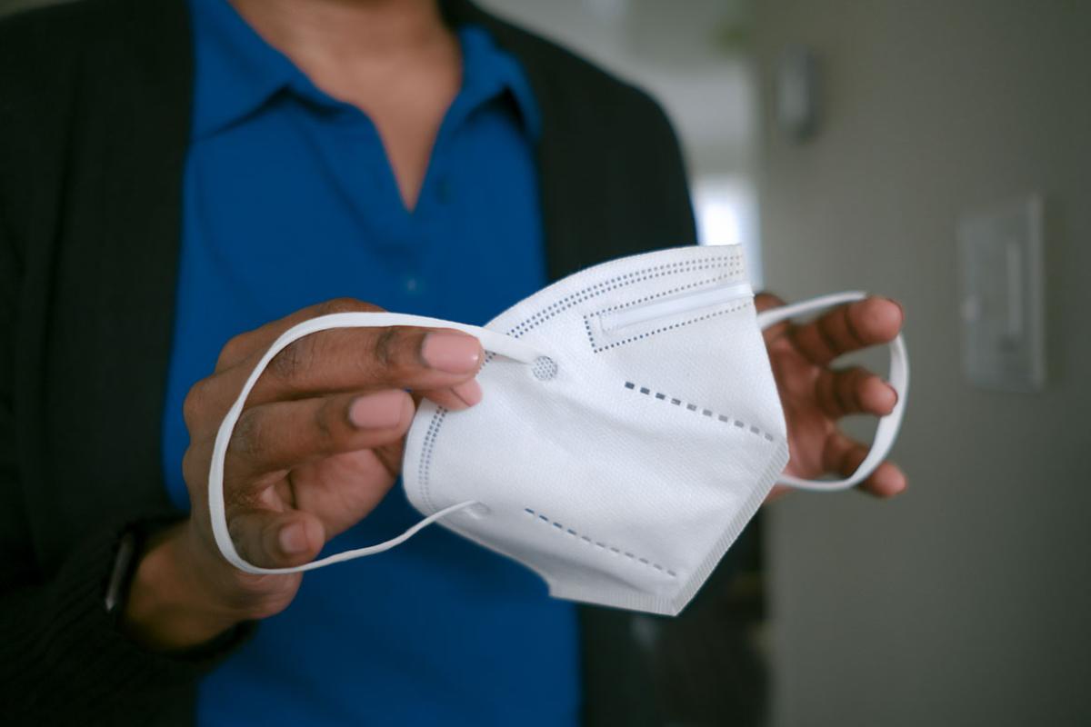 Person holding a KN95 face mask