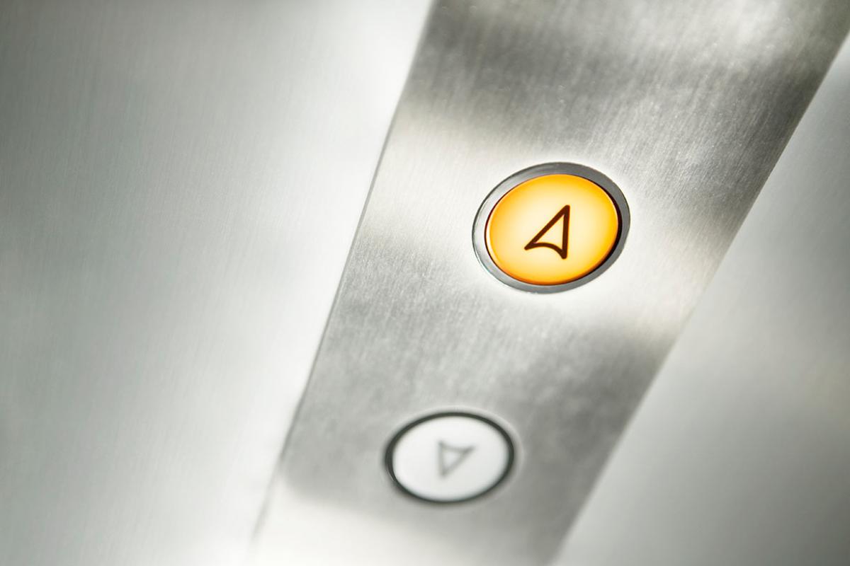 Elevator buttons with the up button illuminated