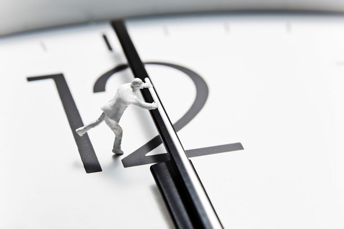 Figure moving the hands of a clock
