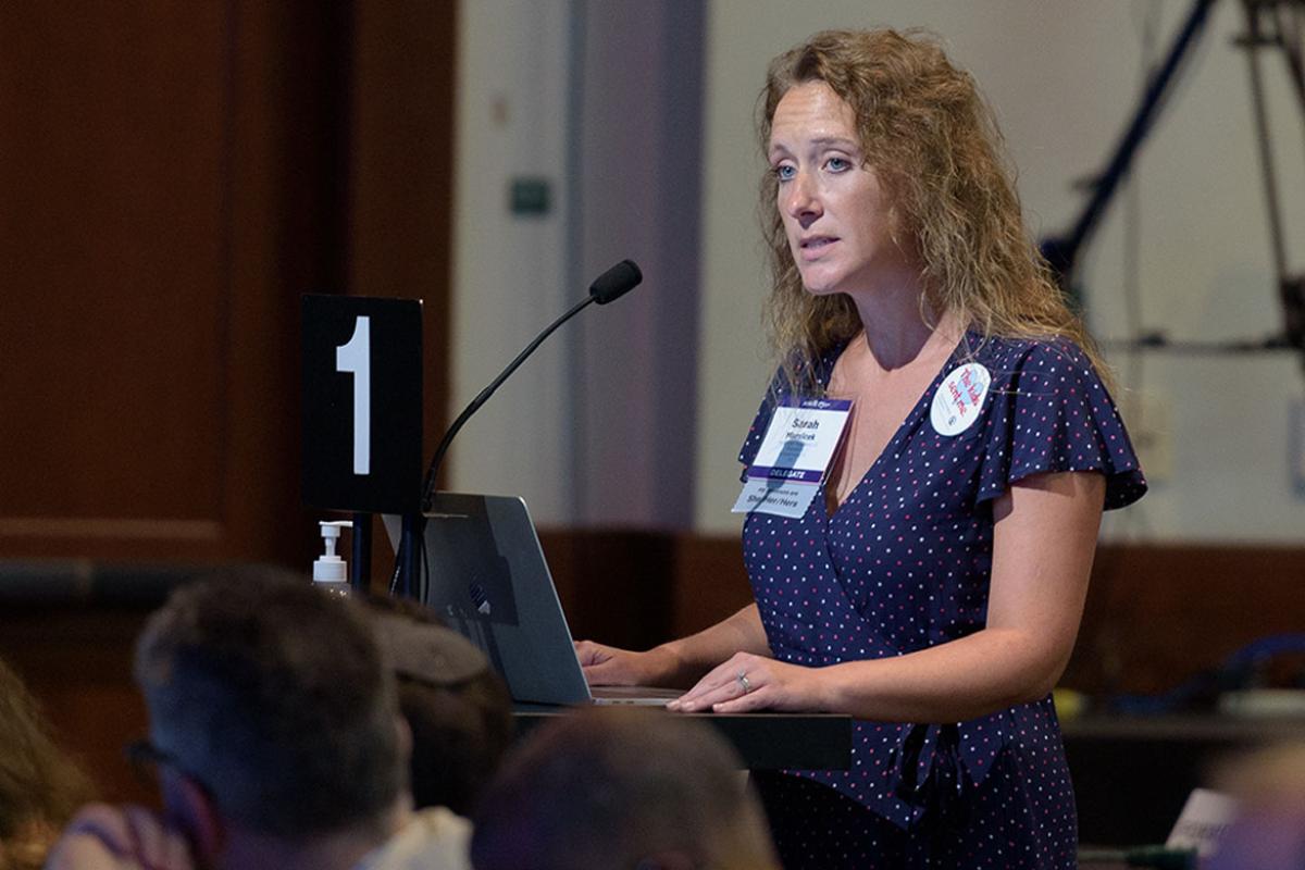 Delegate speaking at podium during 2022 Interim Meeting